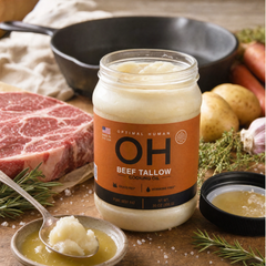 Tallow jar with a spoonful beside raw steak, potatoes and carrots