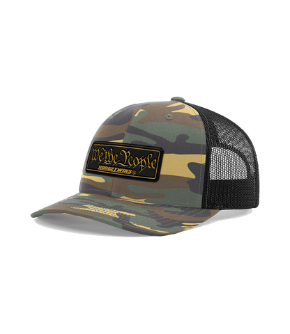 Camo front black mesh OSFA mesh hat with a black and gold leather patch that reads We The People